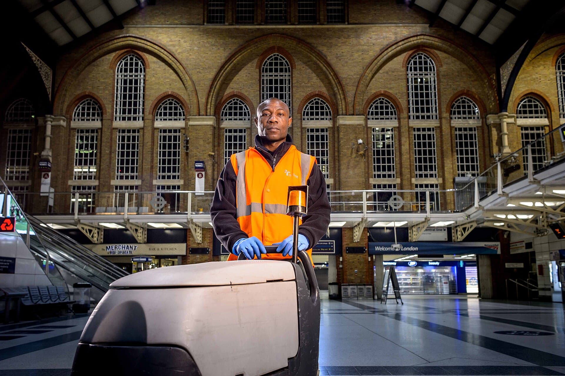 A ride-on floor cleaning machine working a busy railway concourse