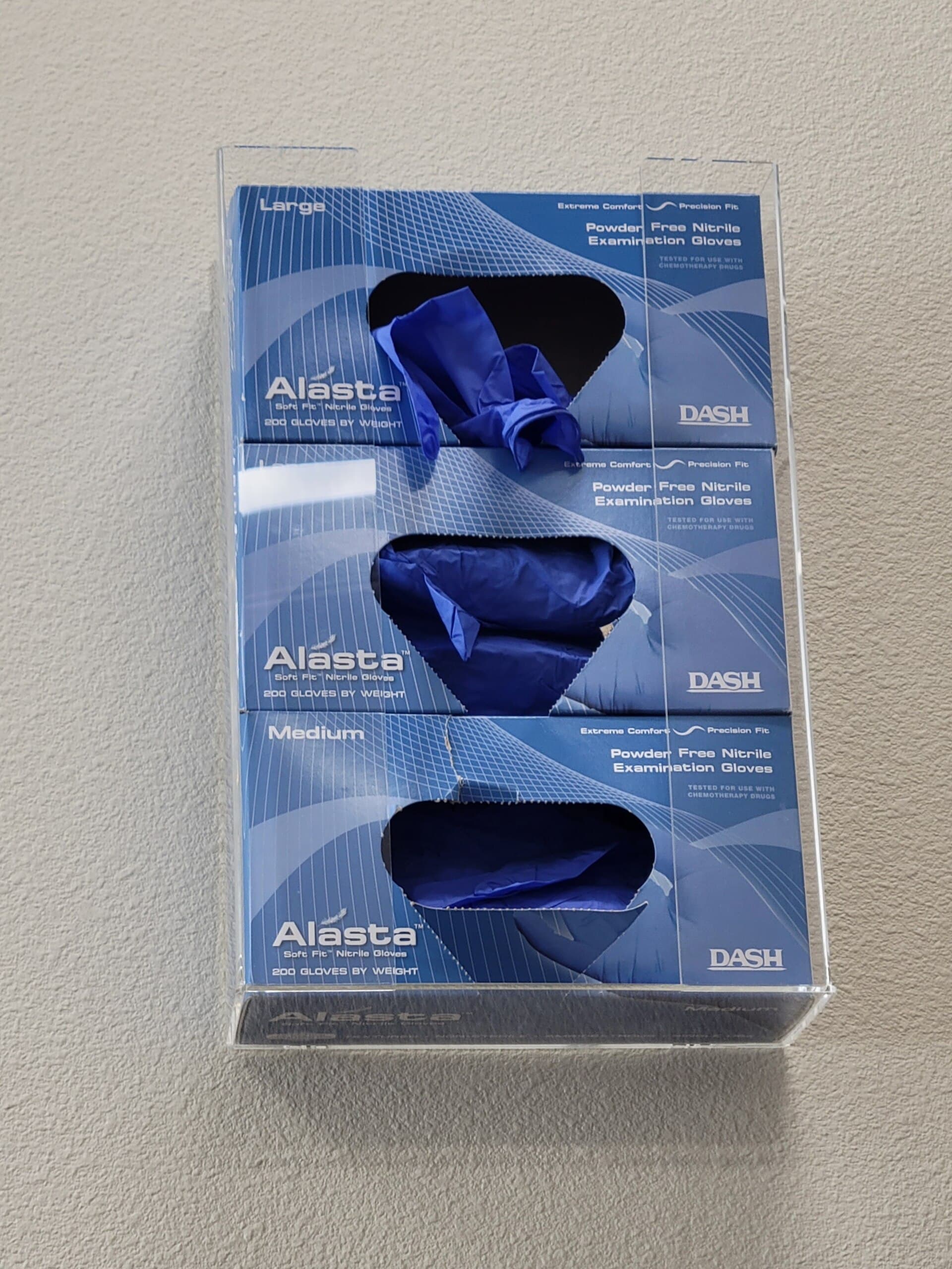 Boxes of nitrile gloves in a wall-mounted dispenser