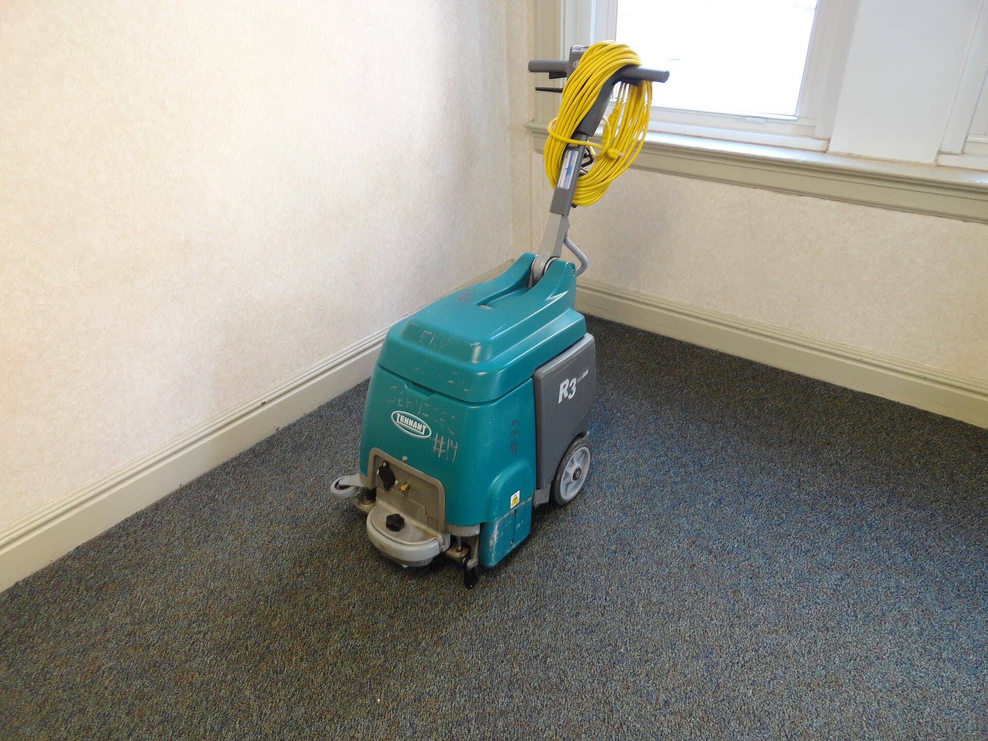 A Tennant carpet cleaning machine in a university hallway
